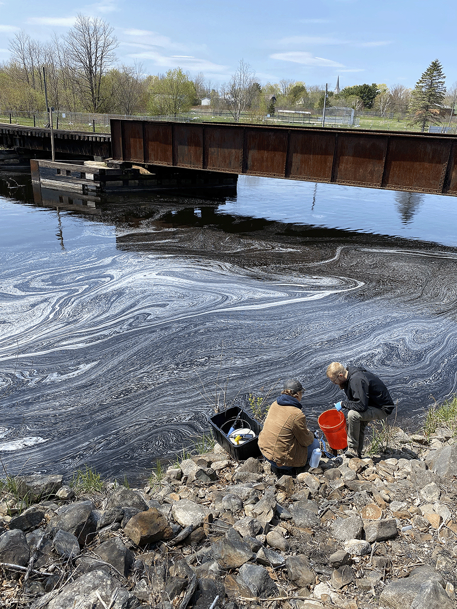 Scientists collecting samples next to a river